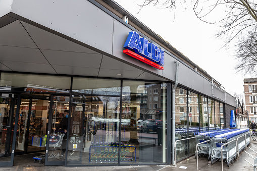 Oss, Netherlands - February 10, 2019: ALDI store in Oss, The Netherlands, Europe. ALDI is a german discount market chain with headquarter in Mühlheim an der Ruhr, Germany. Logo of ALDI SÜD on the facade. Sunday morning - almost no people in the store.