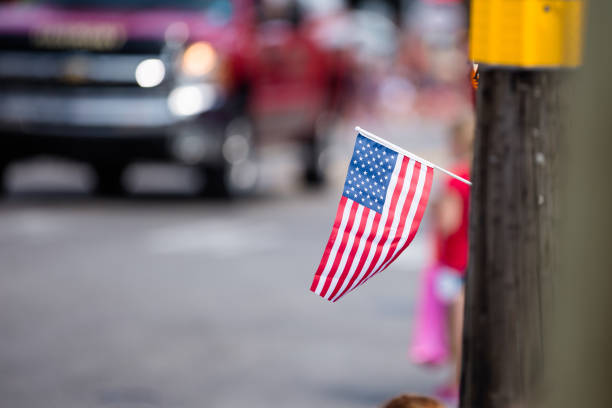 istock Girl Waving American Flag at a Parade 1128969737