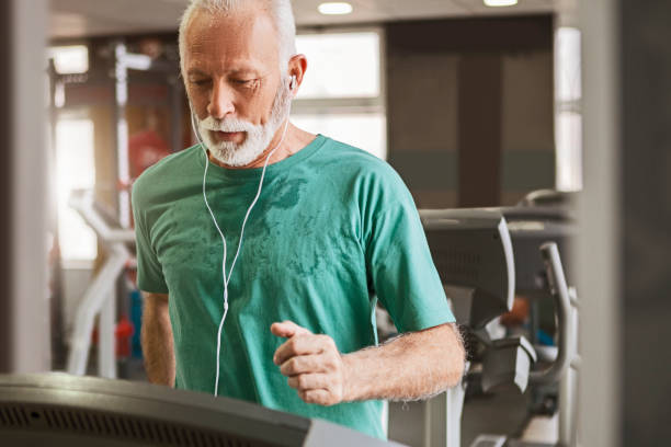 Senior man training cardio on a treadmill Senior man training cardio training one senior man only stock pictures, royalty-free photos & images