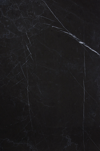 The texture of the natural stone is dark marble with patterns and white stripes, the stone is called Nero Marquina.
