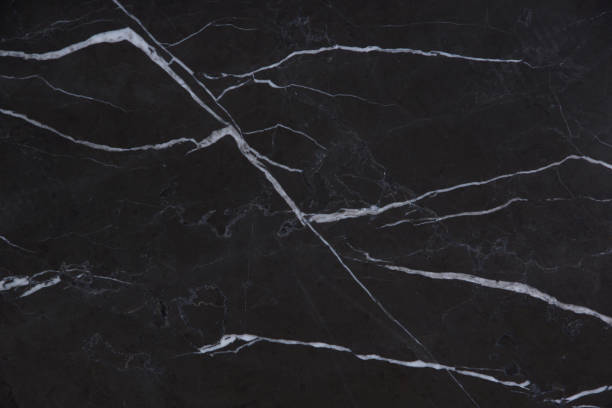 istock The beautiful background of natural black marble stone with white stripes, folded pattern in the form of painted mountains, is called Nero Marquina 1128971226