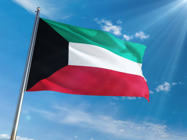 istock Kuwait National Flag Waving on pole against sunny blue sky background. High Definition 1128971526