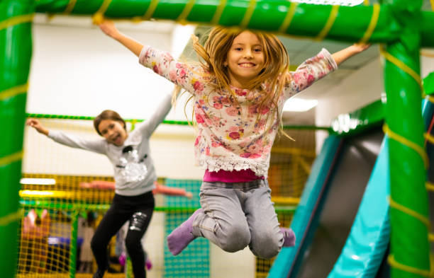 istock Happy girl jumping on trampoline 1128972533
