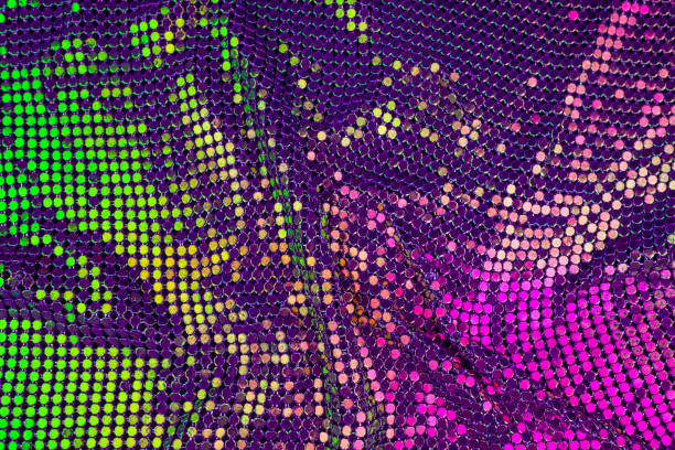 istock Abstract background with gold, green and purple sequins on the fabric. 1128976240