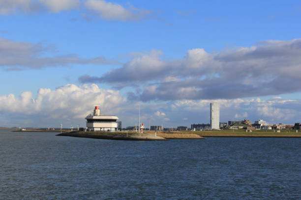 istock the skyline in terneuzen, holland with a blue sky with white clouds 1128980235