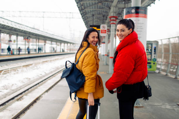 istock Two girlfriends going to trip by railway train 1128981091