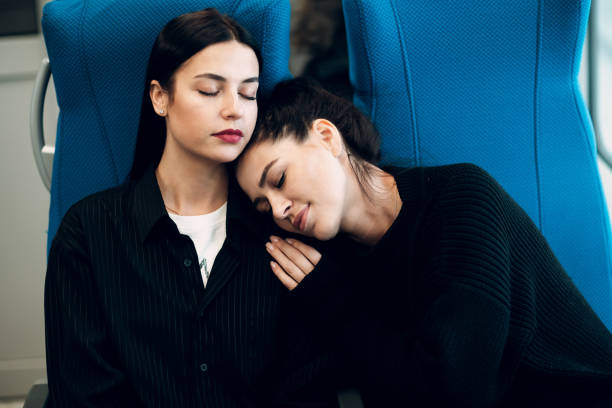 istock Two girlfriends sleeping during trip by railway train.  Women Friendship Concept. 1128981105