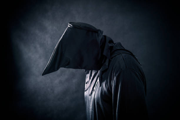 istock Spooky monster in hooded cloak 1128981442