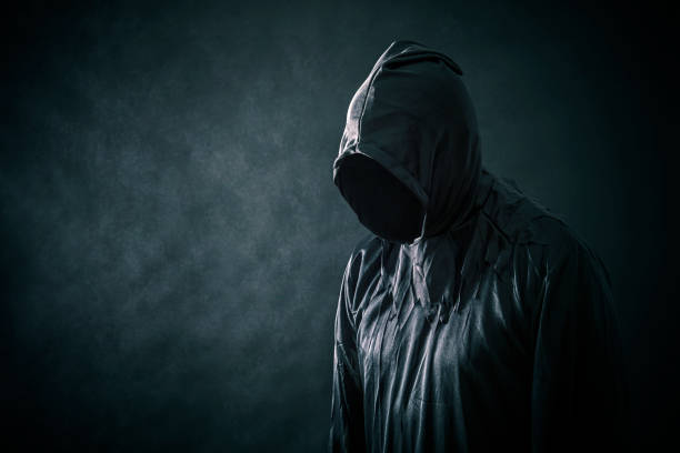 istock Scary figure in hooded cloak 1128982008