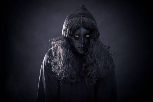 istock The witch in hooded cloak 1128982608