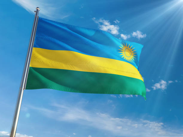 istock Rwanda National Flag Waving on pole against sunny blue sky background. High Definition 1128982776