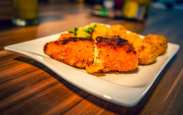istock Chicken, potato balls and healthy salad 1128983453