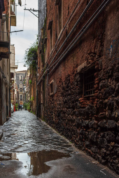 istock An old alley in a puddle 1128983594