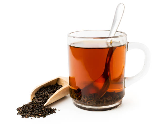 istock Black tea in glass Cup and wooden spoon on a white 1128984052