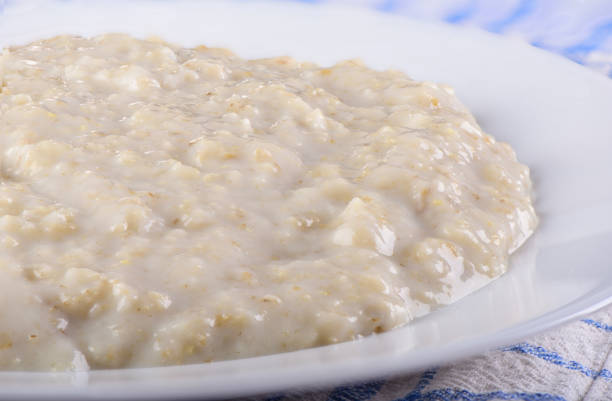 istock Healthy oatmeal closeup on a white plate 1128984154