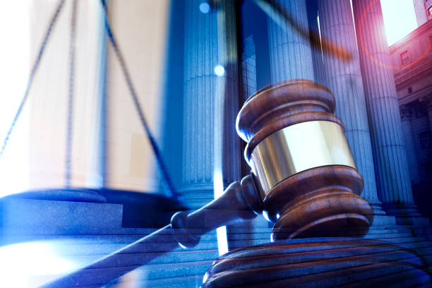 istock Multiple Exposure Of A Gavel And Greek Columns 1128985924