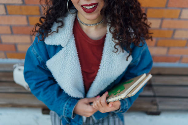 istock Female student with book in college campus 1128987455