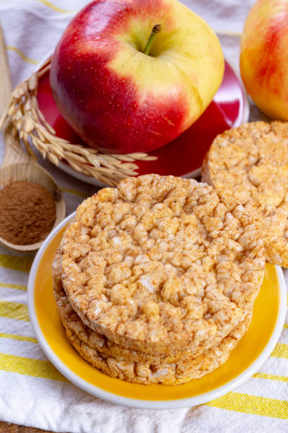 istock Round rice crackers made with apple and cinnamon, healthy snack for breakfast, lunch and school food 1128988770