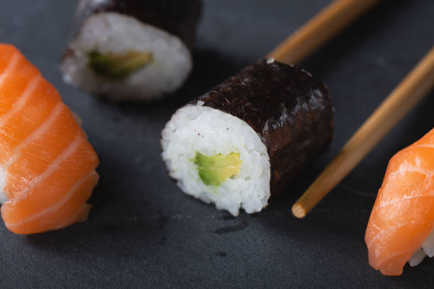 istock Fresh seafood sushi meal on darck background 1128989658