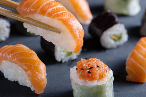 istock Fresh seafood sushi meal on darck background 1128990029