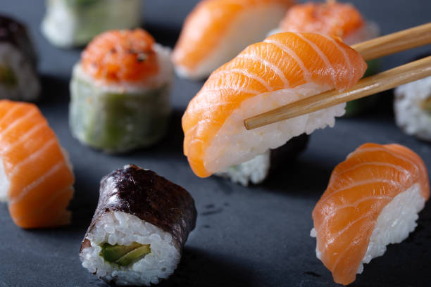 istock Fresh seafood sushi meal on darck background 1128990075