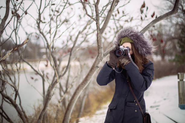 istock a young woman taking a picture 1128990954