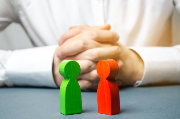 istock The arbitrator examines the conflict situation between people. Search for solutions and compromises. Conflict of interest. Smoothing disputes. Court and law. Justice. Verdict. Legal support 1128990994