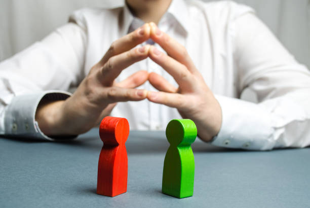 istock The arbitrator examines the conflict situation between people. Search for solutions and compromises. Court and law. Justice. Verdict. Legal support. Conflict of interest. Smoothing disputes. 1128990996
