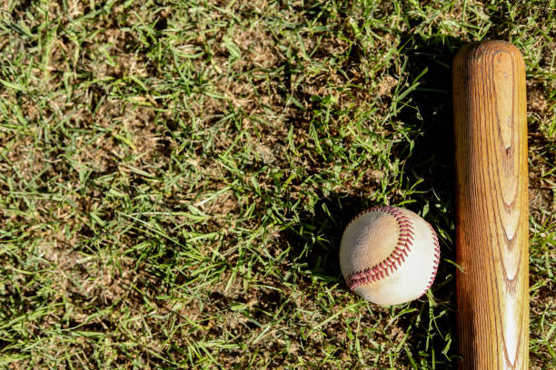 istock Baseball playoff season is here.  Weathered ball, bat on field. 1128991365