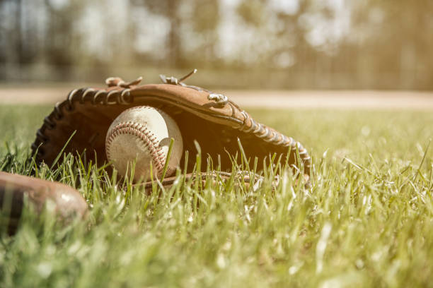 istock Baseball season is here.  Bat, glove and ball on field. 1128991406