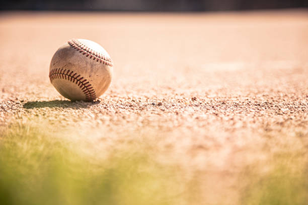 istock Baseball season is here.  Weathered ball on field. 1128991497
