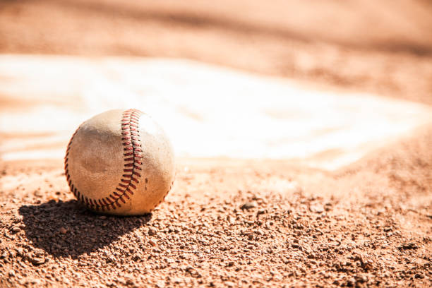 istock Baseball season is here.  Weathered ball on home plate. 1128991509