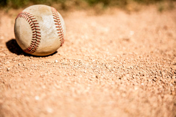 istock Baseball season is here.  Weathered ball on field. 1128991551