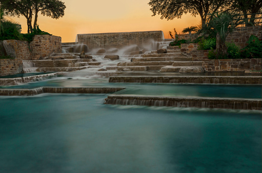 one of the calming meditation ponds at sunset under the Towers of the Americas in Hemisfair park in downtown San Antonio Texas, United States
