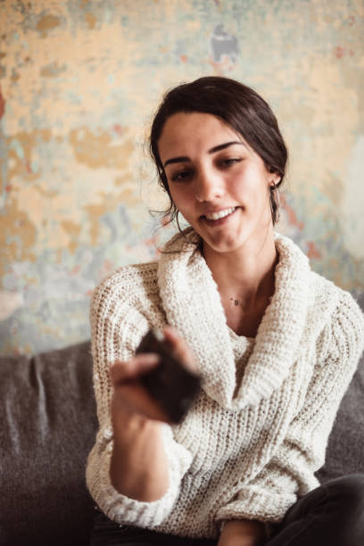 istock beautiful turskish woman watching tv 1128995307