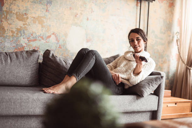 istock beautiful turskish woman watching tv 1128995374