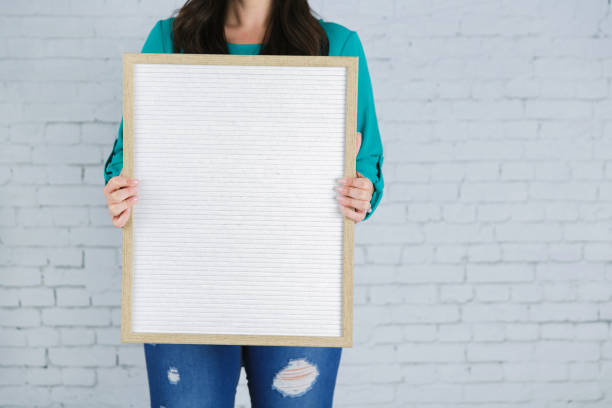 istock Beautiful Woman Against a White Brick Wall 1128995641