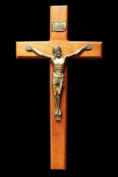 istock Wood crucifix isolated on black 1128996706