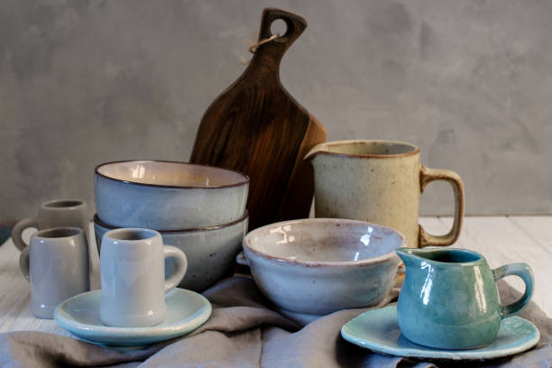 istock Collection of rustic simple handcraft kitchenware in neutral tones on grey background 1128996820