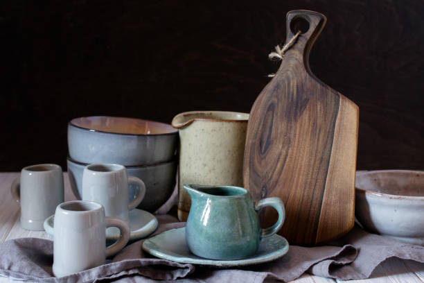 istock Collection of rustic simple handcraft kitchenware in neutral tones on grey background 1128996834