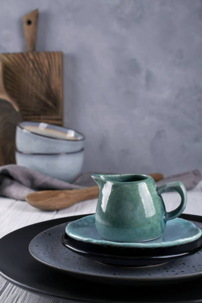 istock Collection of  natural  rustic  handmade crockery tableware in neutral tones on grey background 1128996941