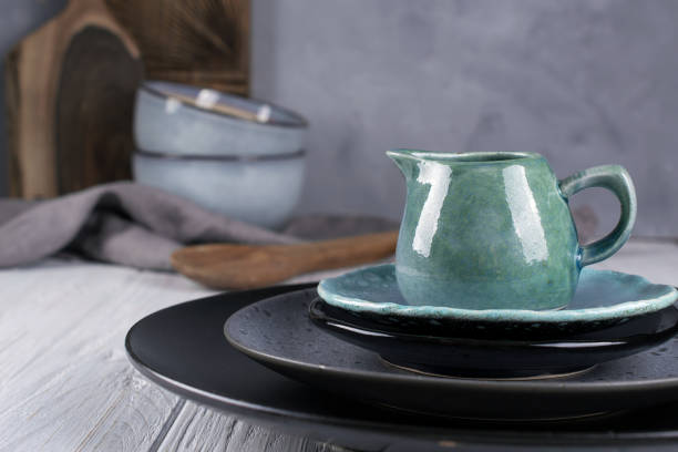 istock Collection of  natural  rustic  handmade crockery tableware in neutral tones on grey background 1128996943