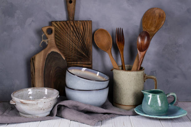 istock Collection of rustic simple handcraft kitchenware in neutral tones on grey background 1128996960