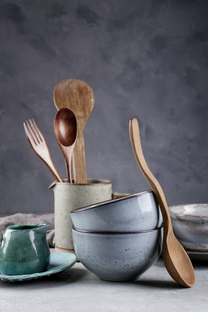 istock Collection of  natural  rustic  handmade crockery tableware in neutral tones on grey background 1128996999