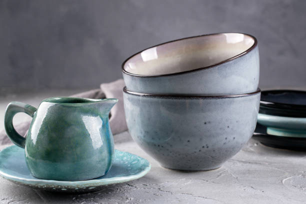 istock Collection of rustic simple handcraft kitchenware in neutral tones on grey background 1128997025