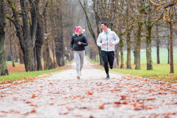 istock Young couple jogging outdoors 1128997728