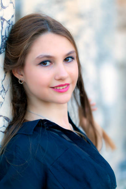 A beautiful Caucasian woman with a nose piercing looking at the camera