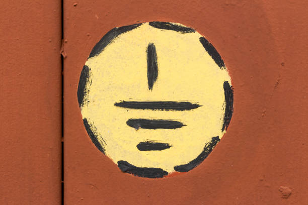 National flag of US state of New Mexico, the red sun sign, Zia symbol, yellow on Independence Day, against a background of a brick wall with peeling paint. Political and religious disputes, delivery.