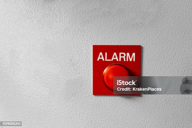 Red Alarm Button Signal On The Painted Grey Wall Concept Of Any Alarm Situation Fire Bankrupt Robbery Etc Stock Photo - Download Image Now