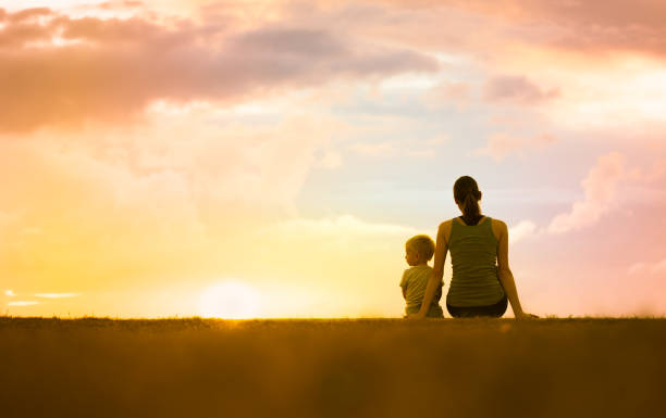 istock Mother with her son watching beautiful sunset. 1129005298
